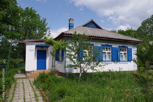 old house with white walls and blue shutters