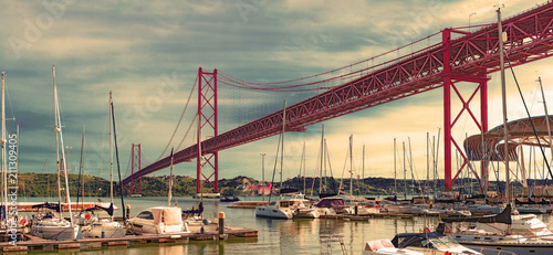 Bridge of April 25 in Lisbon.Cityscape of Lisbon and seaport. Entertainment and leisure in Portugal.Boats, sailboats and yachts in the port