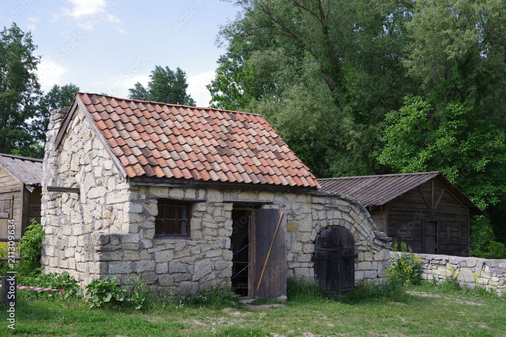 small stone building near trees small stone building near trees