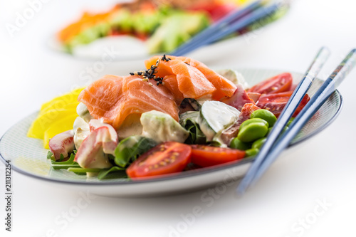 Japanese salad with fish salmon and vegetable and chopsticks