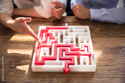 Close-up Of Maze Puzzle With Red Arrow