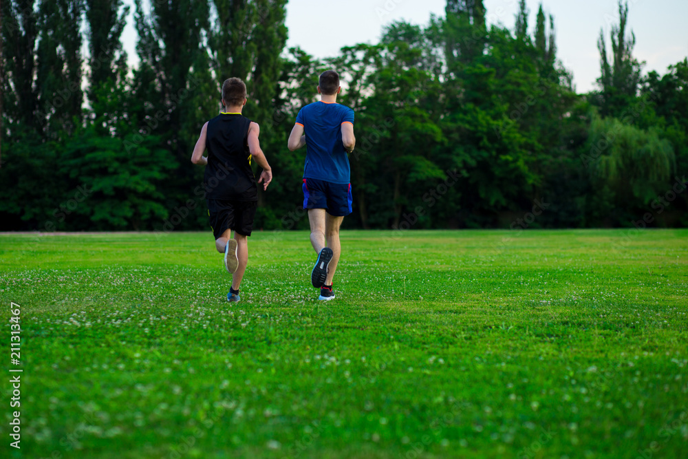 Athletic young man running in nature. Healthy lifestyle Athletic young man running in nature. Healthy lifestyle