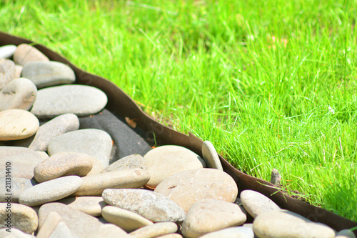 Konstfotografi A fragment of landscaping. Stones meet a green grass.