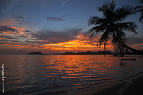 swing or cradle hang on the coconut tree beautiful sunset at koh Mak beach Trad Thailand