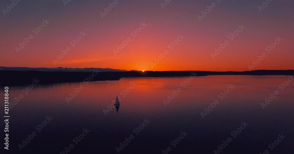 Aerial - Flying Over A Sailboat On Calm Waters At Sunset Aerial - Flying Over A Sailboat On Calm Waters At Sunset