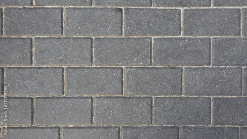 Rectangular gray cobblestones of the pavement. Top view