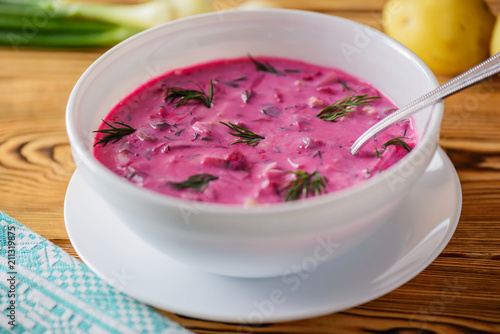 Cold beetroot (beet) soup on yogurt with egg, onion and cucumbers