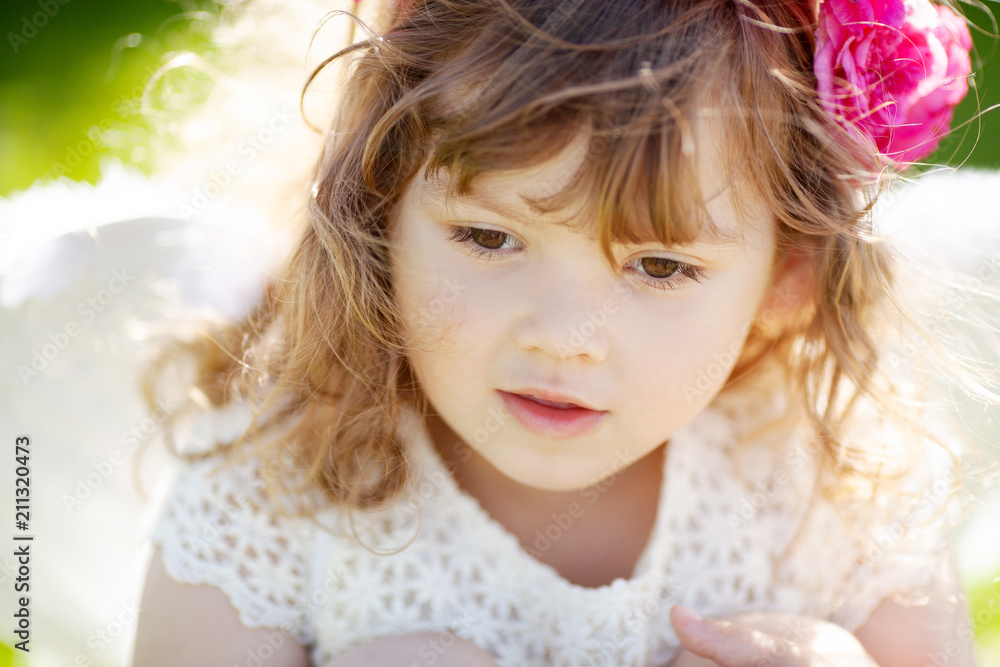 Portrait of beautiful little Angel girl with floral wreath Portrait of beautiful little Angel girl with floral wreath