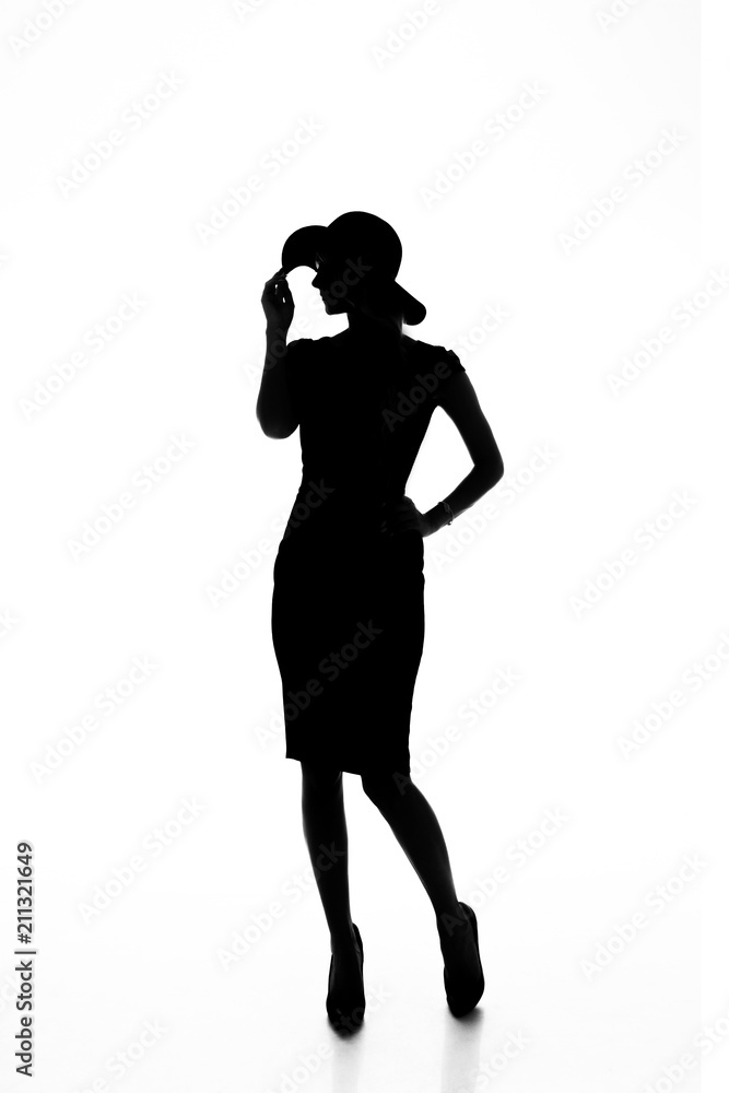 Silhouette of a slender young woman in dress and hat on white isolated background with place for text