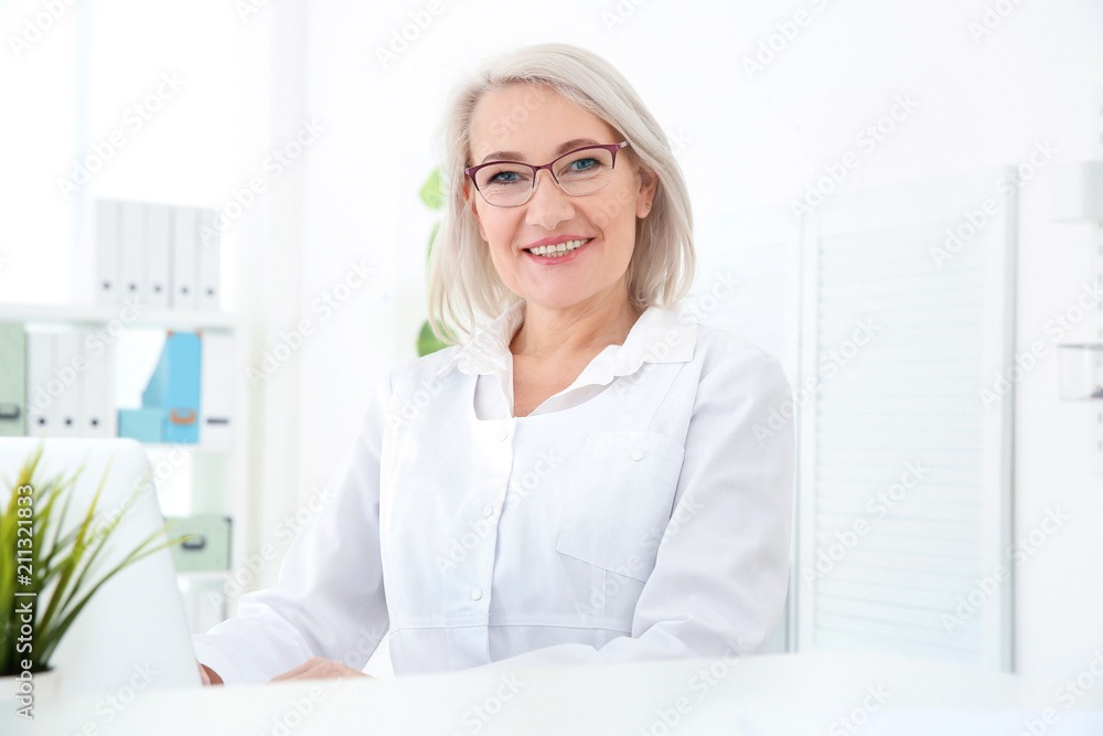 Senior female receptionist working in hospital Senior female receptionist working in hospital