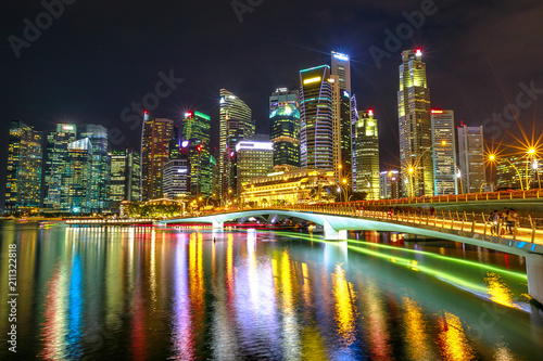 Singapore financial buildings and skyscrapers of downtown reflected in the sea of the harbor. Singapore skyline by night. Night scene waterfront marina bay. © bennymarty