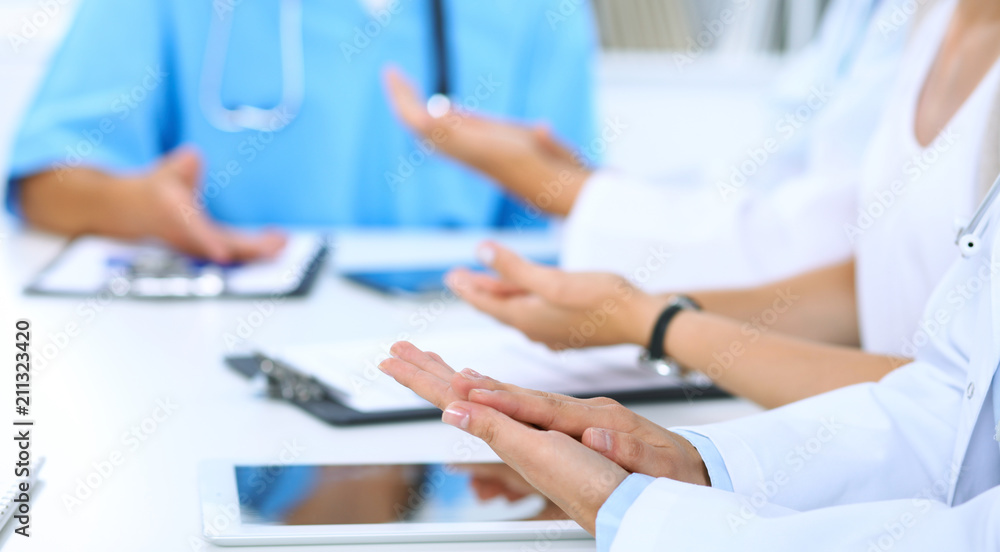 Group of doctors applauding at medical meeting. Close up of physician hands. Teamwork in medicine Group of doctors applauding at medical meeting. Close up of physician hands. Teamwork in medicine