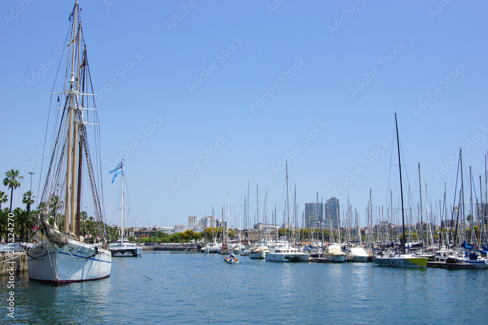 Sailboat harbor, many beautiful sail yachts and boat in the sea port of Barcelona. Water transport in summertime vacation