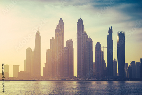 Vintage sunrise view of Dubai marina with noise and grain effect 