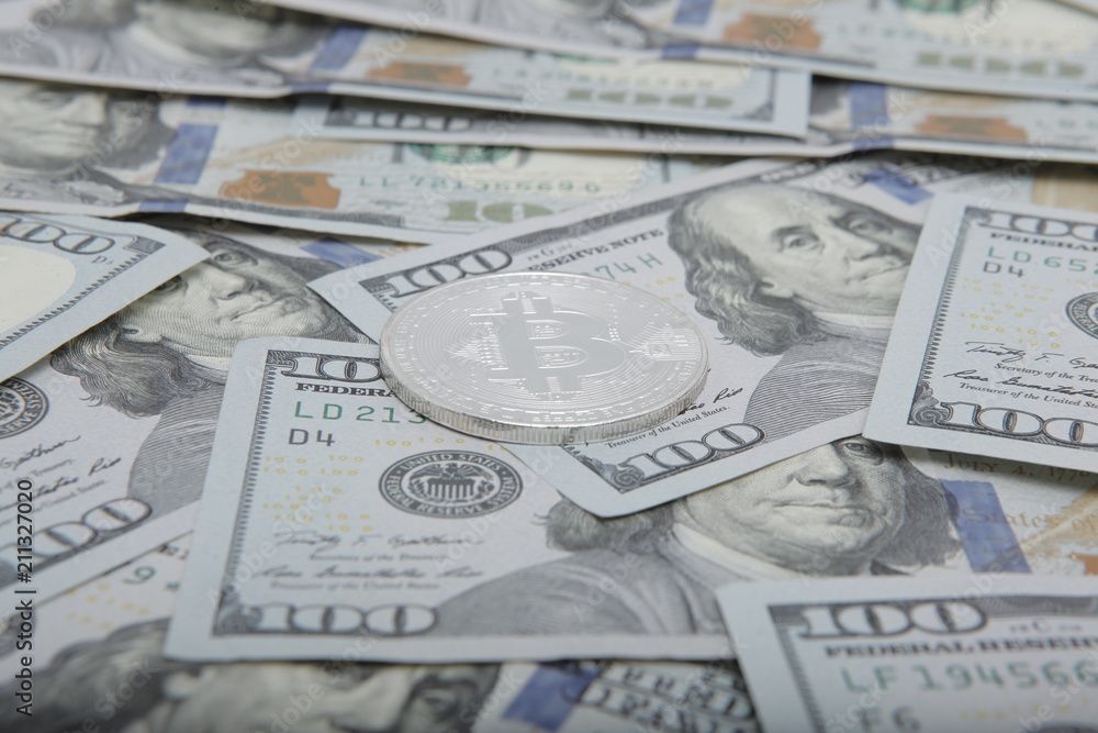coins of the bitcoin against the background of dollar notes. bitcoin the most Popular cryptocurrency in the world coins of the bitcoin against the background of dollar notes. bitcoin the most Popular cryptocurrency in the world