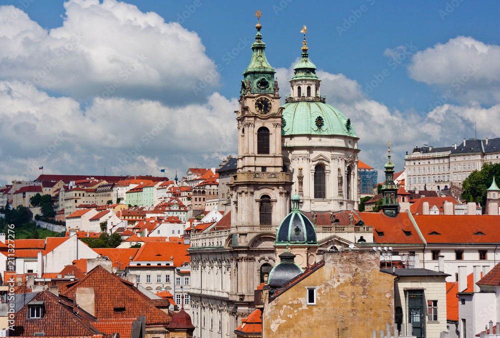 St. Nicolas churc over old town red roofs. Prague, Czech Republic