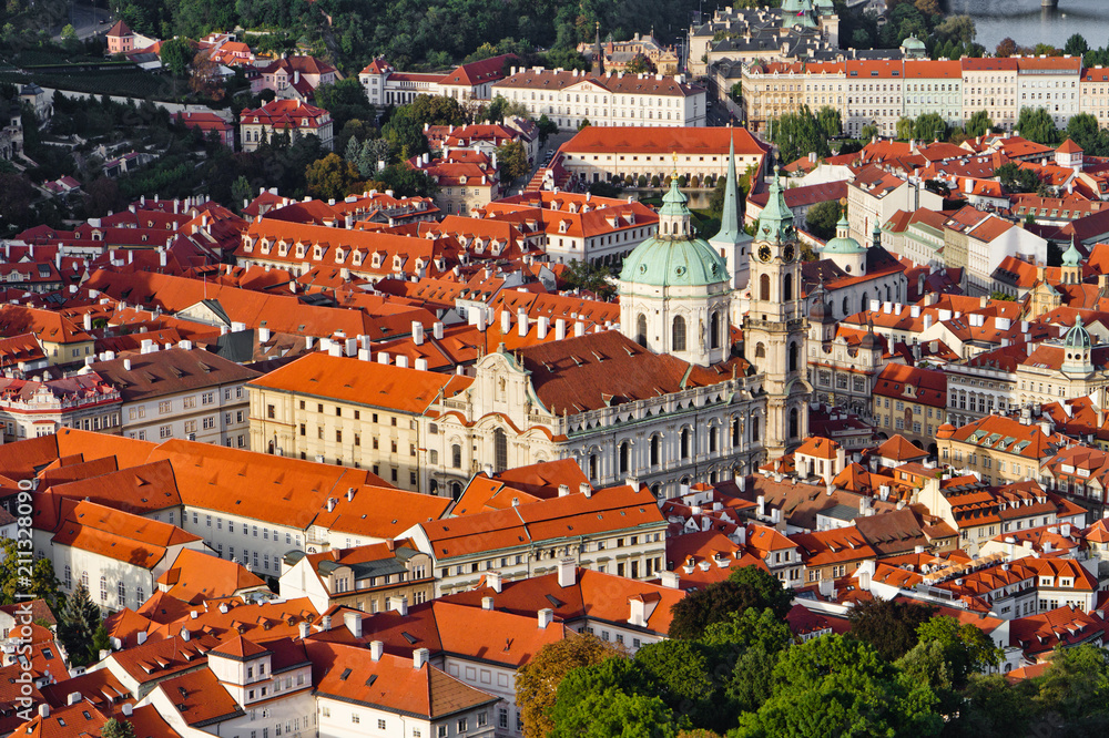 Aerial view of the city. St. Nicolas churc over old town red roofs. Prague, Czech Republic