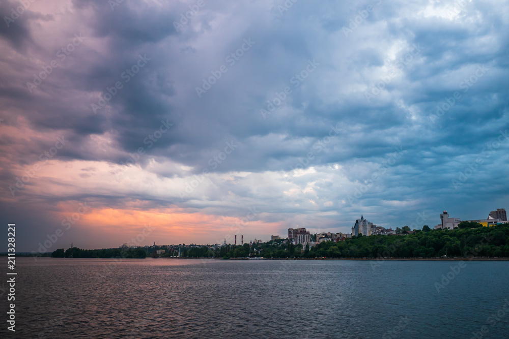 Beautiful dramatic storm clouds over Voronezh city, Russia. Panorama landscape with river and cloudscape