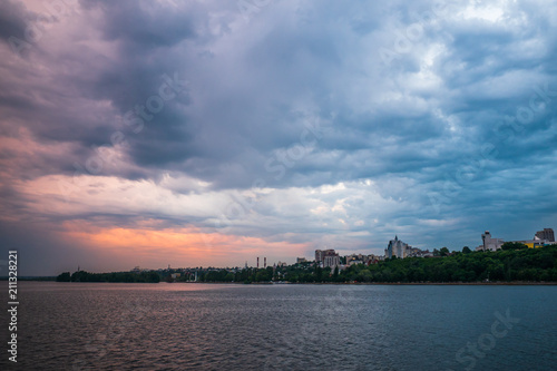 Beautiful dramatic storm clouds over Voronezh city, Russia. Panorama landscape with river and cloudscape
