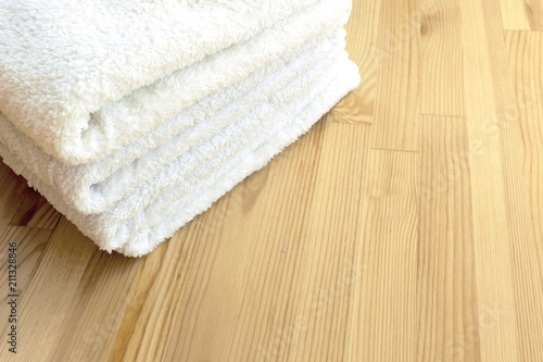 White towels on a light wooden background