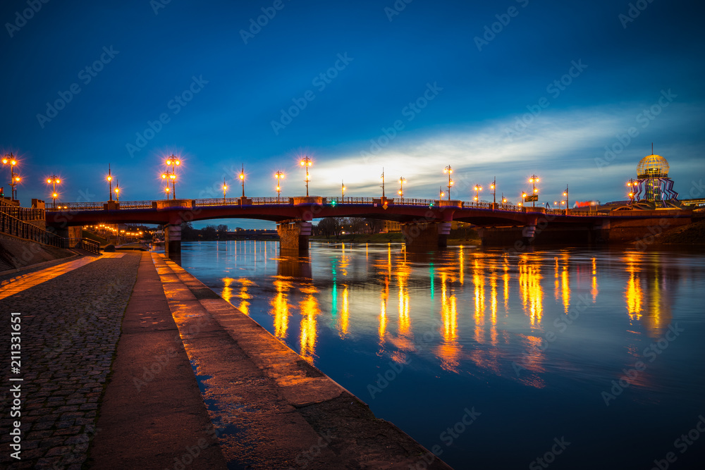 Fototapeta premium Old Town bridge and Warta river at dusk in Gorzow, Poland