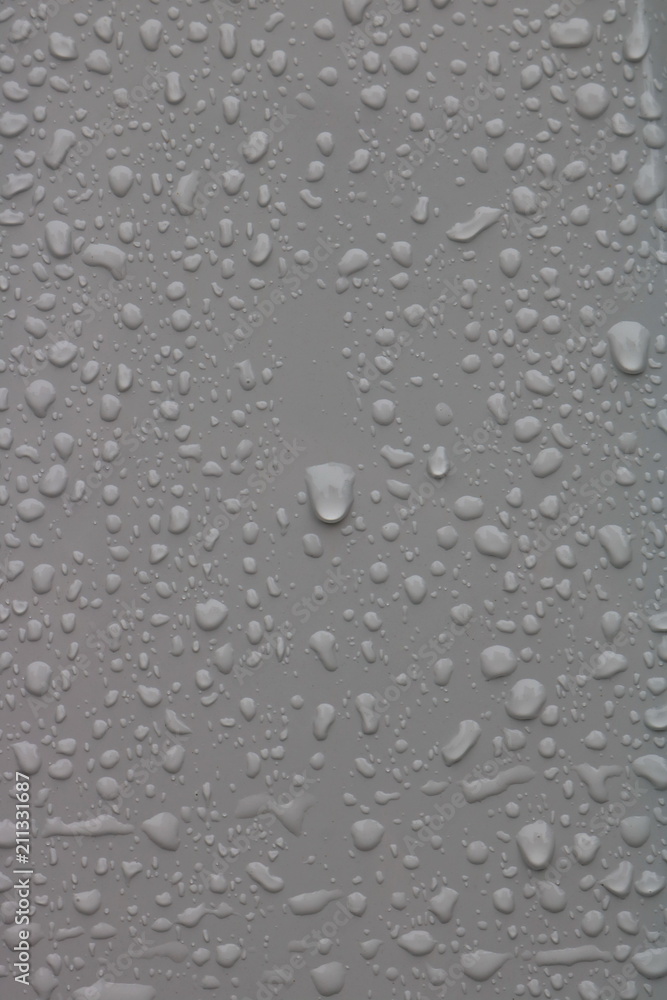 Water drops on a white metal surface 