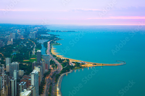 View of Chicago Illinois and Lake Michigan with beaches, buildings and roads in view at sunset