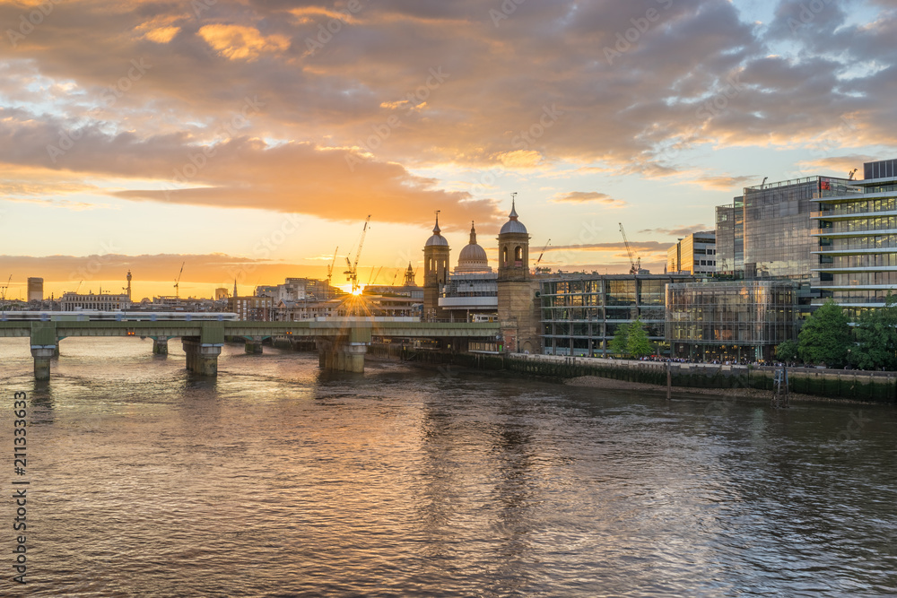 Southwark bridge and St.Paul's cathedral at sunset in London, England