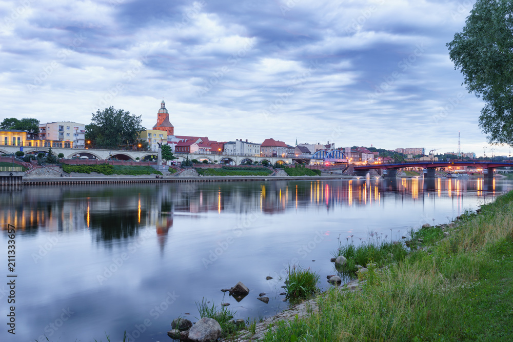 Evening panorama of Warta river,Old Town bridge and boulevard in Gorzow Wielkopolski, Poland Evening panorama of Warta river,Old Town bridge and boulevard in Gorzow Wielkopolski, Poland