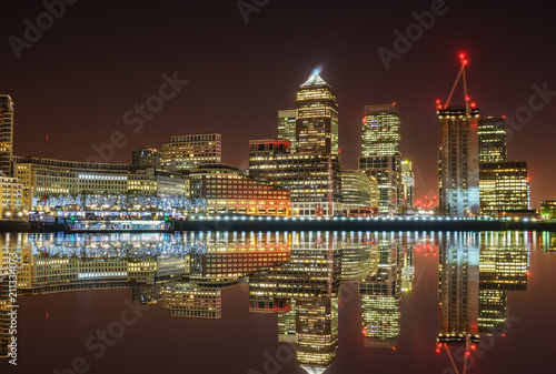 Canary Wharf business district with water reflection and christmas lights at night