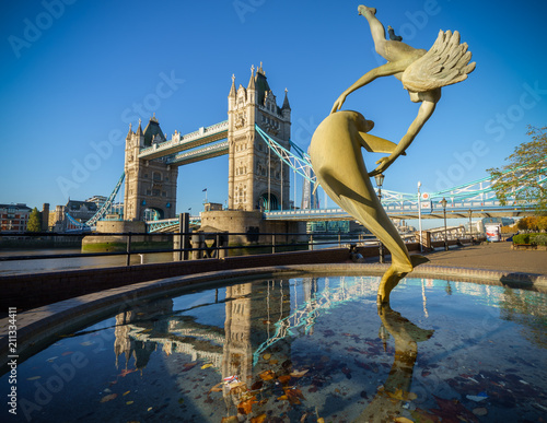 Tower Bridge and statue of a girl playing with dolphin photo