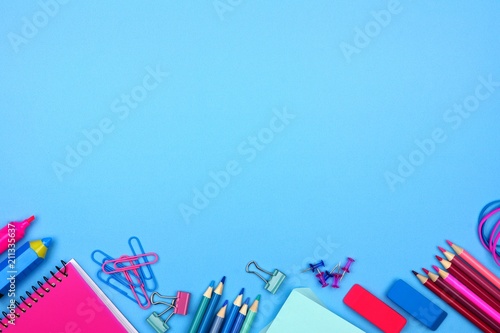 School supplies bottom border against a pastel blue paper background. Pink and blue color theme.
