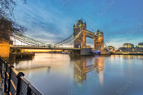 Tower bridge at sunrise with reflection in London,England
