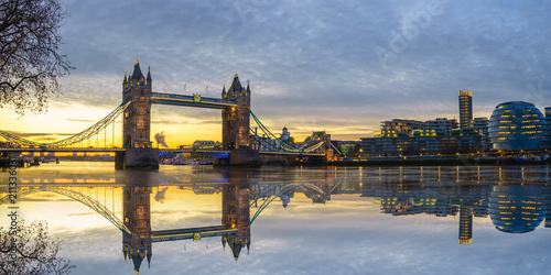 Panoramic view of Tower bridge at sunrise with reflection in London,England