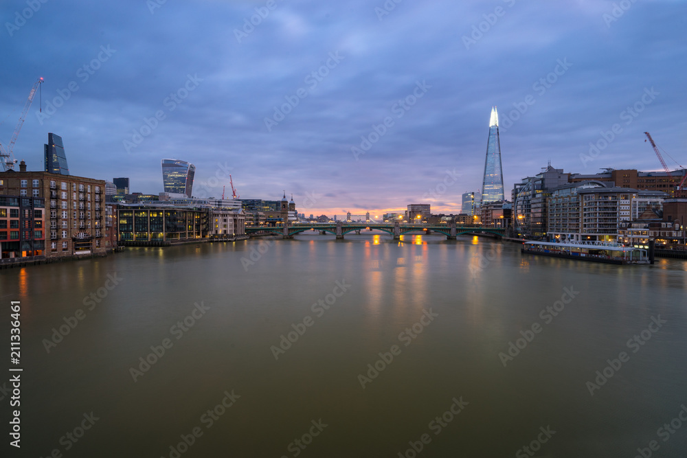 London skyline panorama seen across reiver Thames at dawn. England