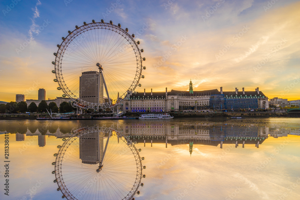 The London Eye with water reflection at sunrise  in London. England