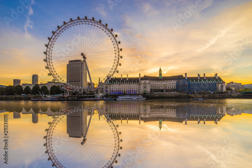 The London Eye with water reflection at sunrise  in London. England