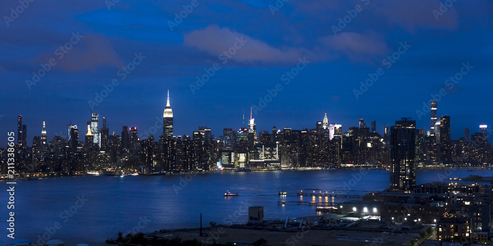JUNE 3, 2018 - NEW YORK, NEW YORK, USA  - New York City and East River shows Chrysler Building on right and Empire State Building on Left, as seen from Queens