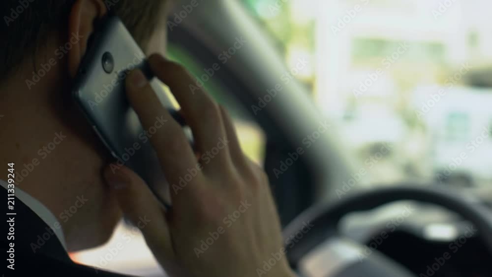 Man nervously talking on cell phone in car, upset over failure, tough day Man nervously talking on cell phone in car, upset over failure, tough day