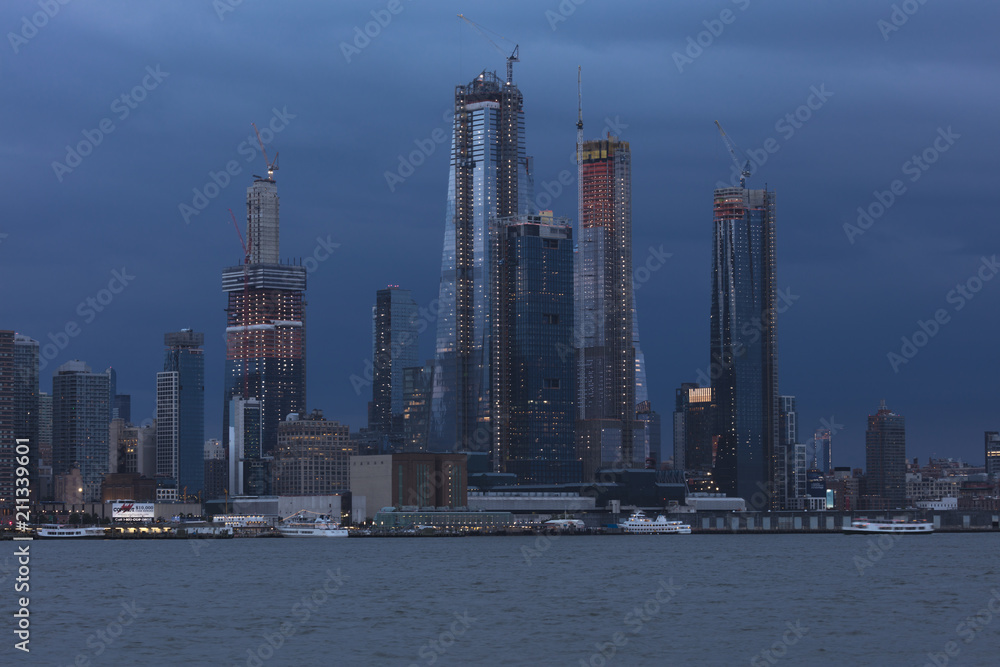 JUNE 6, 2018 - NEW YORK, NEW YORK, USA  - New construction midtown on the Hudson River awith stormy clouds