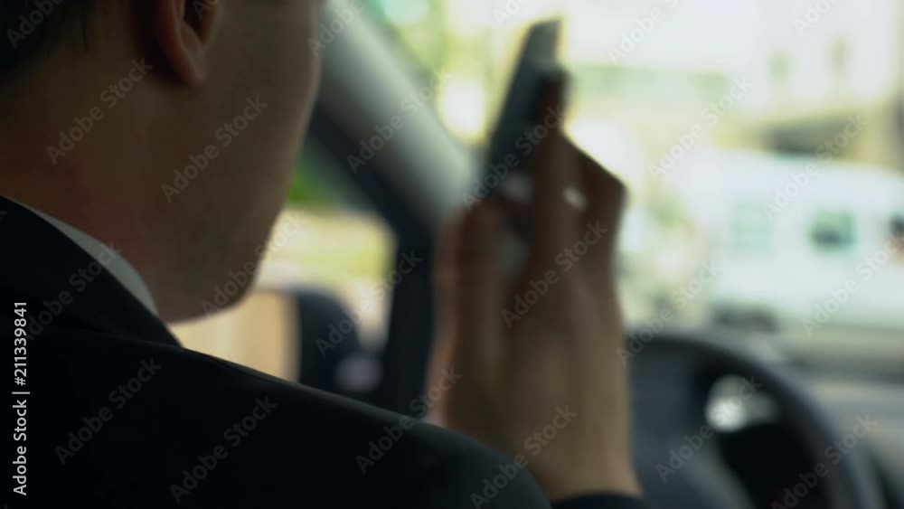 Man drinking coffee, talking on phone while stuck in traffic jam, inattentive Man drinking coffee, talking on phone while stuck in traffic jam, inattentive