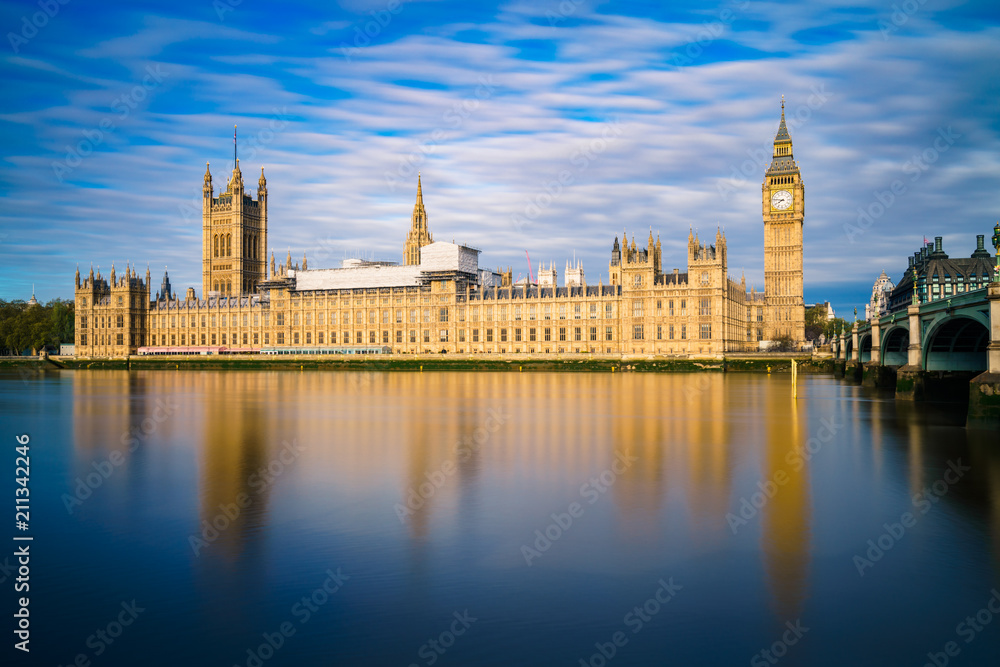 Big Ben and Westminster parliament with colourful blue sky and water reflection Big Ben and Westminster parliament with colourful blue sky and water reflection