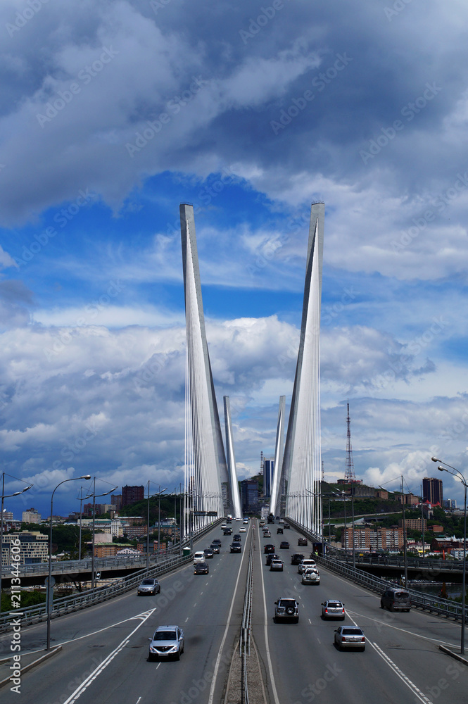 Cable-stayed bridge against the blue sky and clouds
