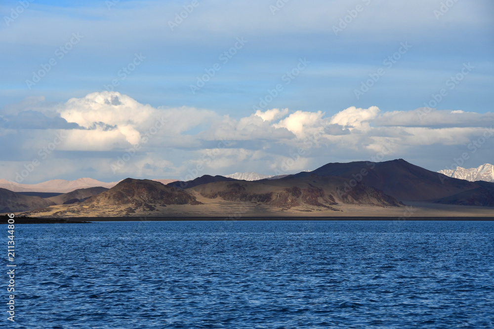 Western Tibet. Sacred lake Dangra (Dang Ra Gyu Tso) in summer evening in cloudy weather Western Tibet. Sacred lake Dangra (Dang Ra Gyu Tso) in summer evening in cloudy weather