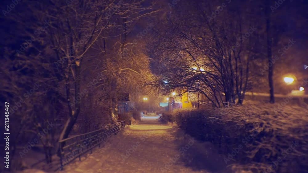 beautifully lit alley on a winter evening during a snowfall beautifully lit alley on a winter evening during a snowfall