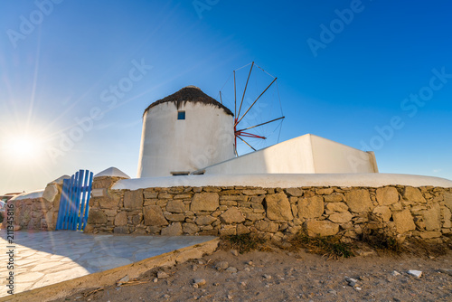 Traditional Greek windmill of Mykonos island with sun flare. Greece
