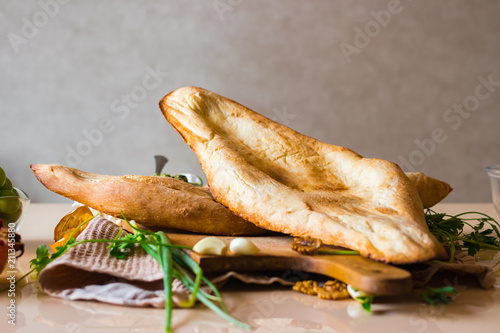 Georgian traditional bread - shoti. Puri made of white wheat flour in round clay oven. This bread is always on table with bunch of greens for Georgian lunch or dinner.
