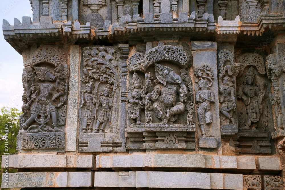 Ornate wall panel reliefs depicting From left Varaha, Kamdev and his wife Rati, and dancing Ganesha. Kedareshwara temple, Halebidu, Karnataka