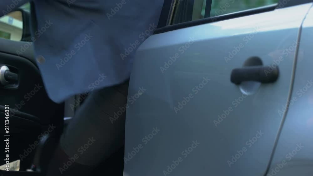 Business lady turning off car alarm and getting into auto, independent woman