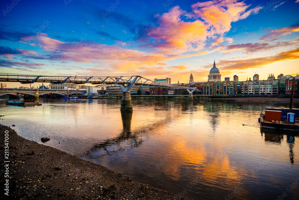 Millennium Bridge and St. Paul's cathedral at sunrise in London